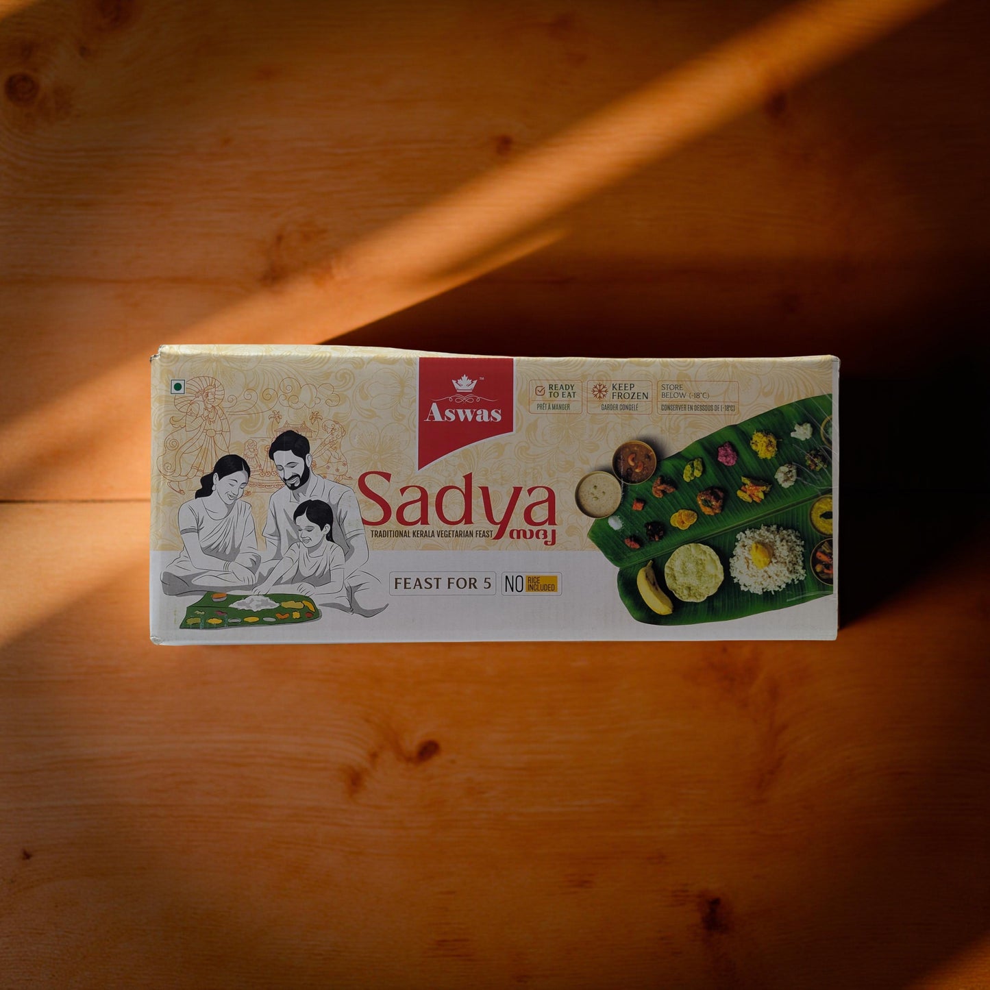 Aswas Sadhya food package on a wooden surface