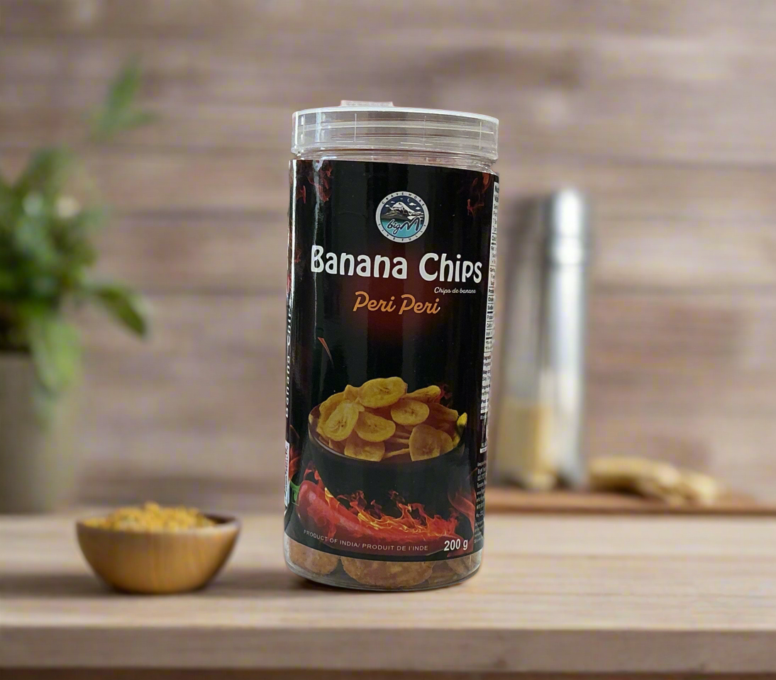 Tub of Banana Chips with Peri Peri flavor on a wooden surface.