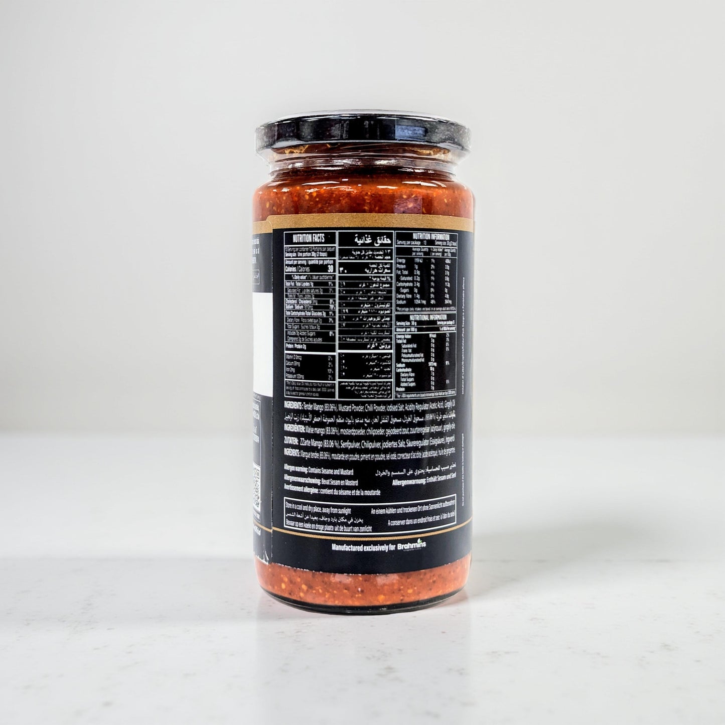 Jar of pasta sauce with a black label on a white background