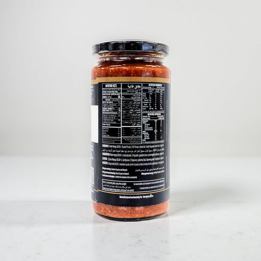 Jar of pasta sauce with a black label on a white background