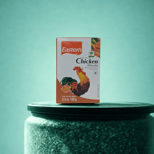 Box of Eastern Chicken Masala on a green surface with a teal background