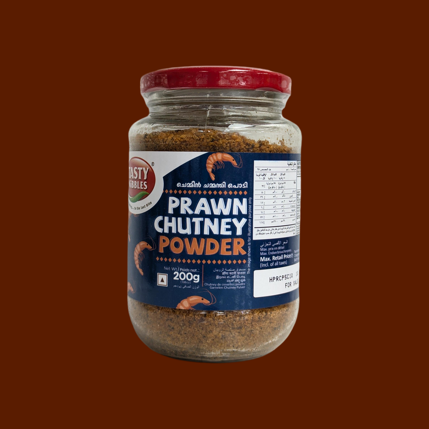 Jar of prawn chutney powder with a red lid on a brown background