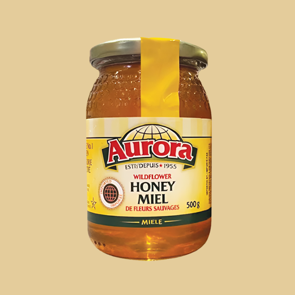Jar of Aurora wildflower honey on a beige background
