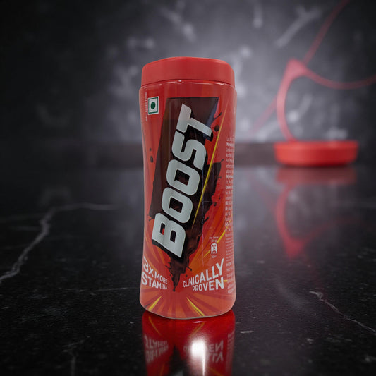 Boost energy drink container on a reflective black surface with a dark background