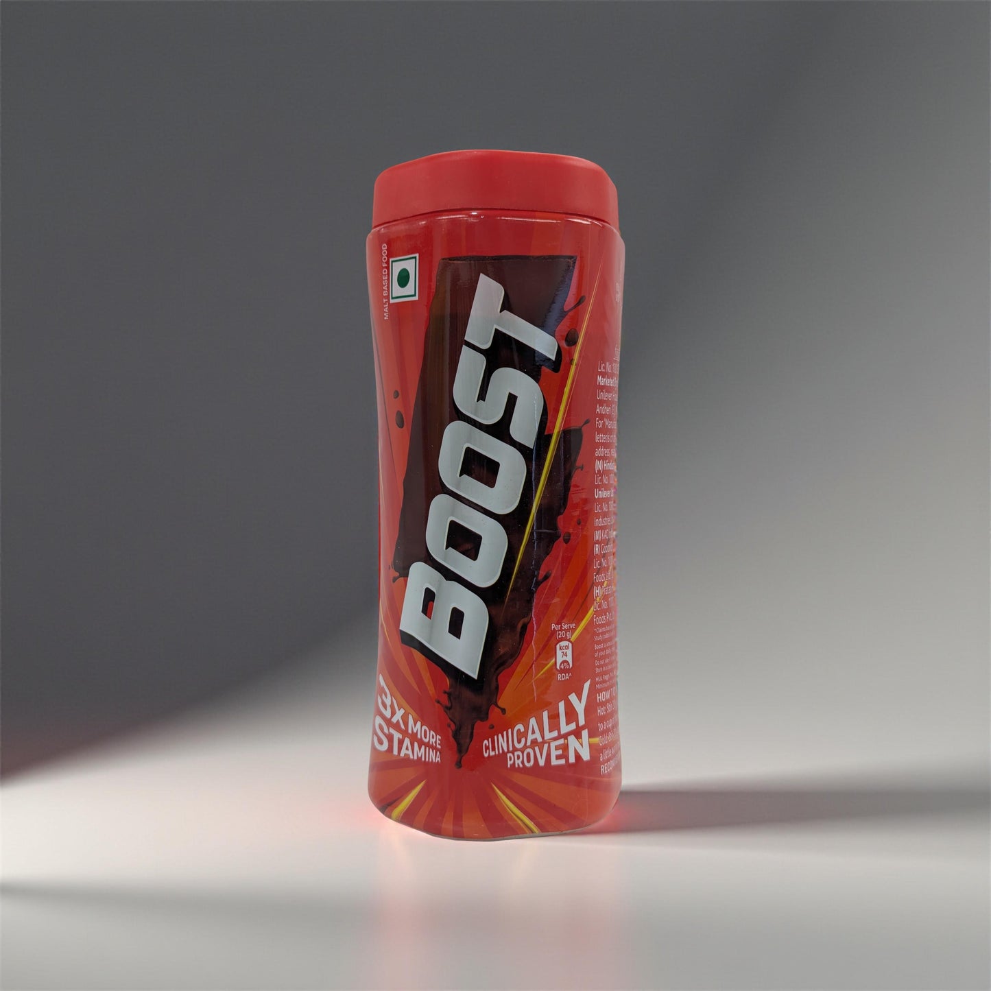 Red Boost energy drink container on a gray background