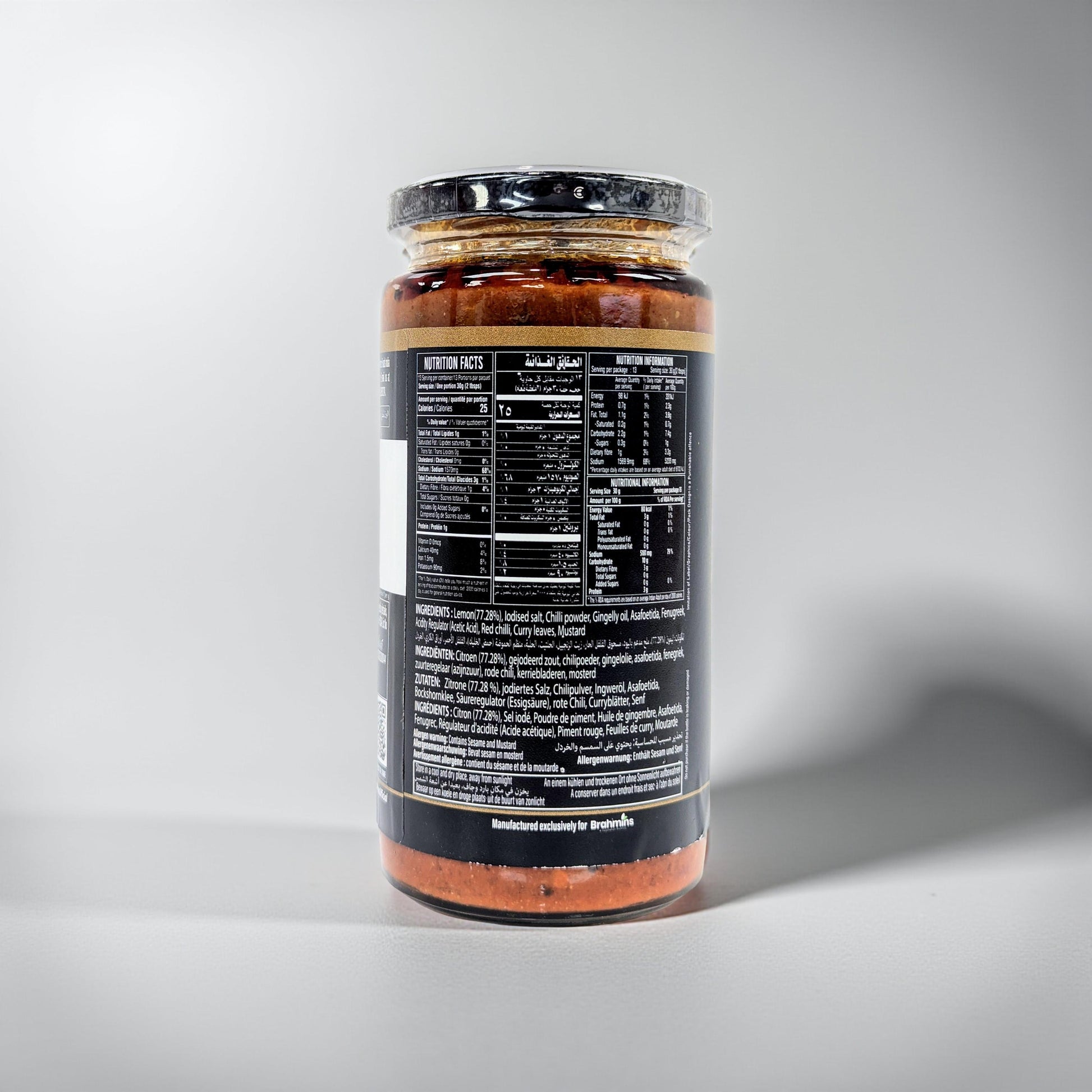 Jar of sauce with a black label on a gray background