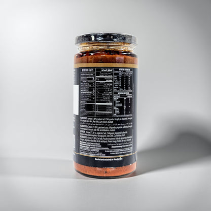 Jar of sauce with a black label on a gray background