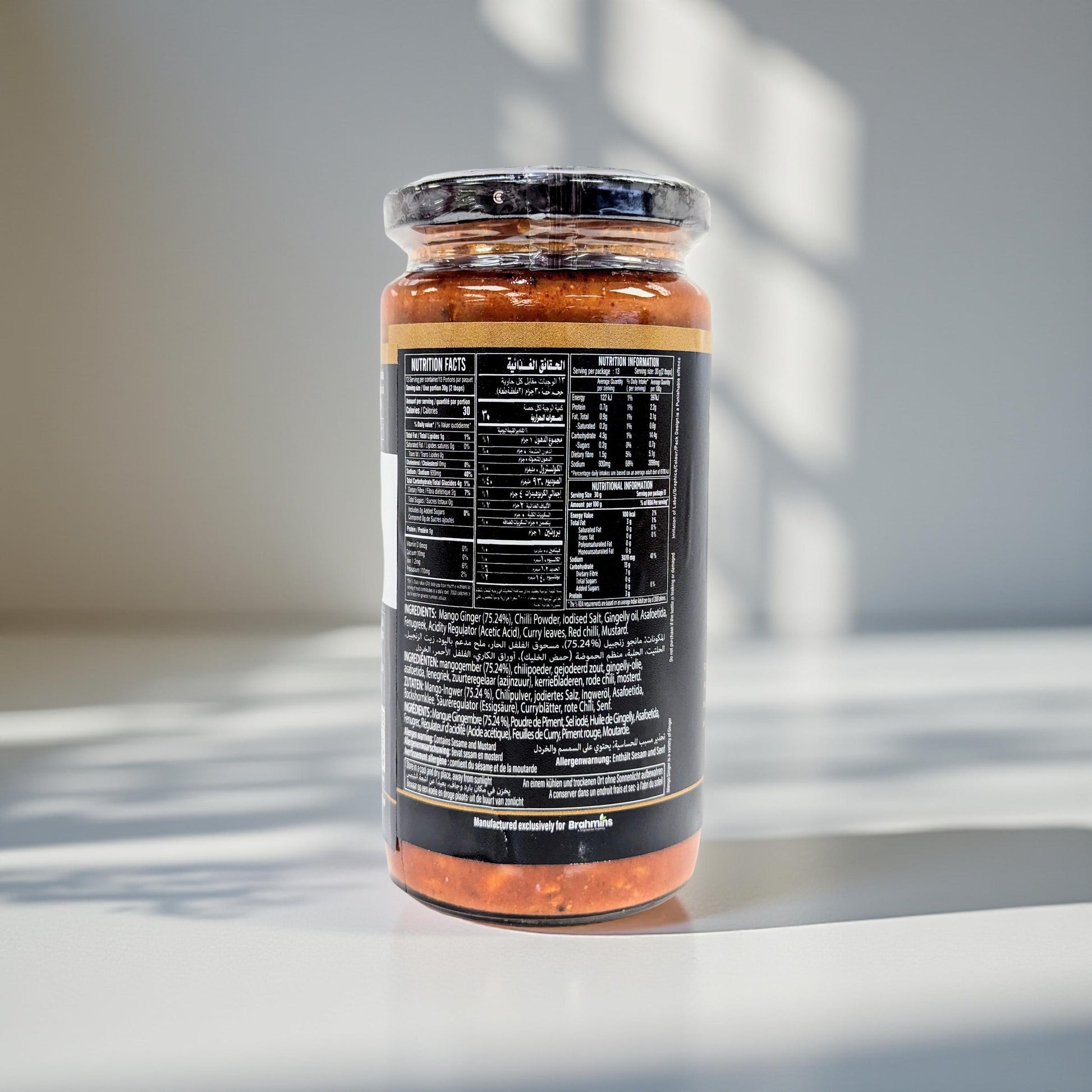 Jar of pasta sauce with nutritional label on a reflective surface