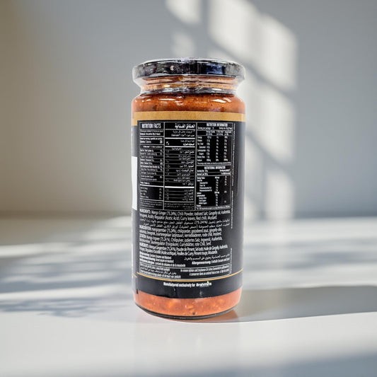 Jar of pasta sauce with nutritional label on a reflective surface