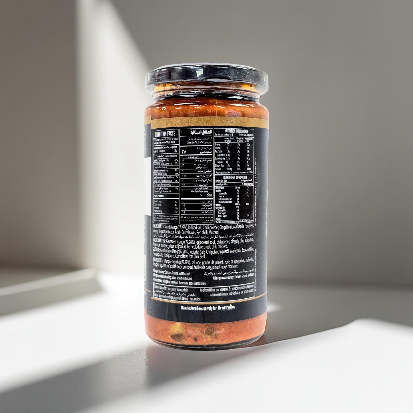 Jar of sauce with a black label on a gray background