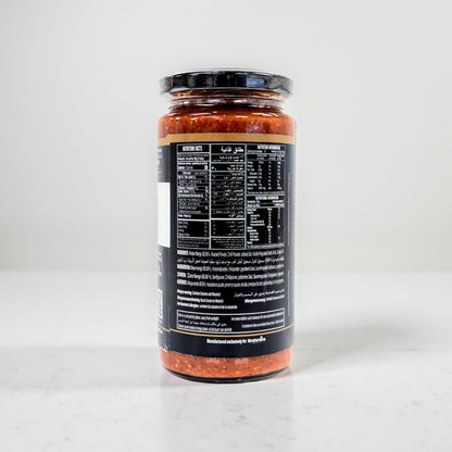 Jar of pasta sauce with a black label on a white background