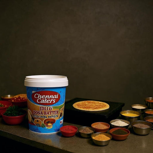 Chennai Caterers idli and dosa batter container with cooking ingredients on a dark background