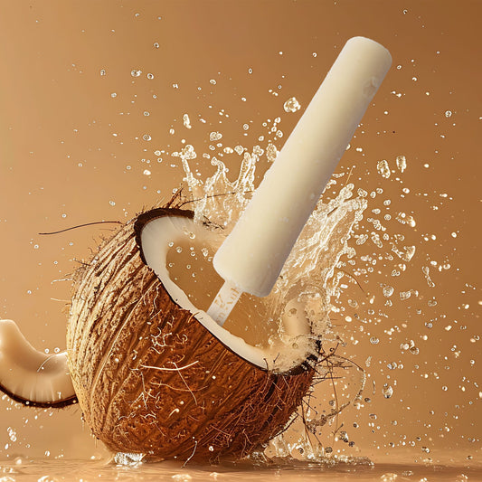Coconut being cracked open with a hammer against a brown background