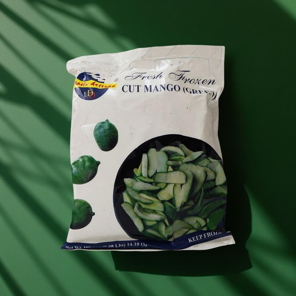 Packaged frozen cut mango on a green background
