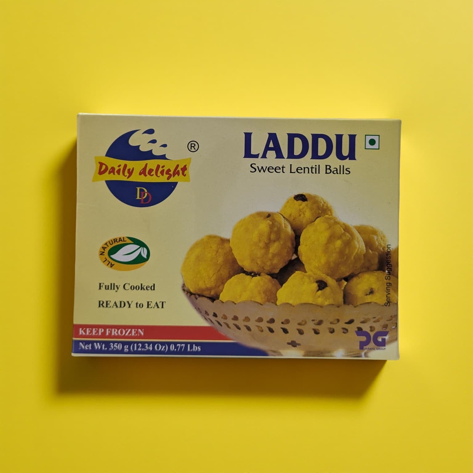Box of Daily Delight Laddu Sweet Lentil Balls on a yellow background