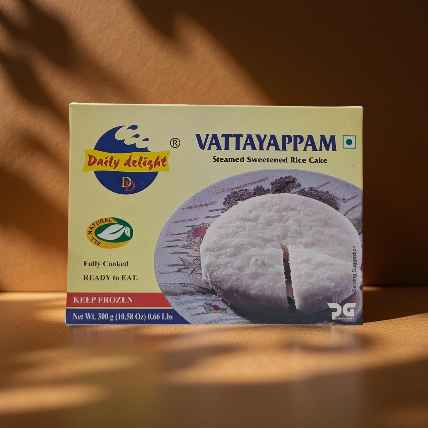 Box of Vattayappam steamed sweetened rice cake on a wooden surface