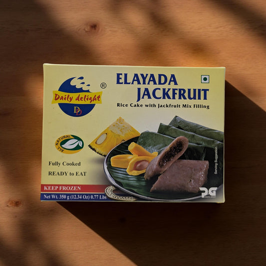 Box of Elayada Jackfruit rice cake with jackfruit mix filling on a wooden surface