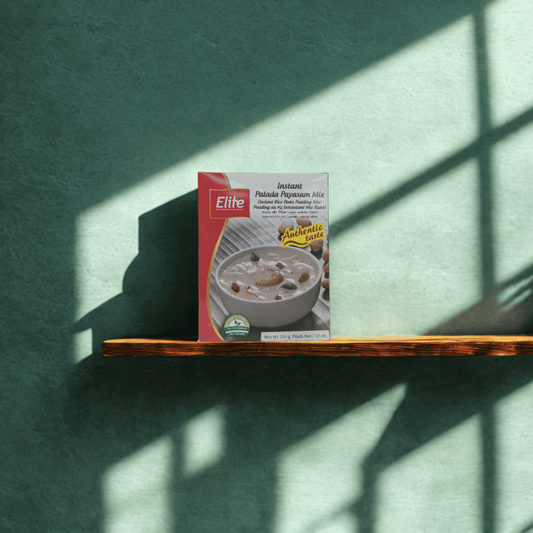 Box of Elite Palatine Pudding Mix on a wooden shelf with a green wall background