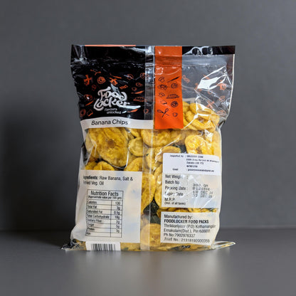 Packaged banana chips with a clear window on a gray background