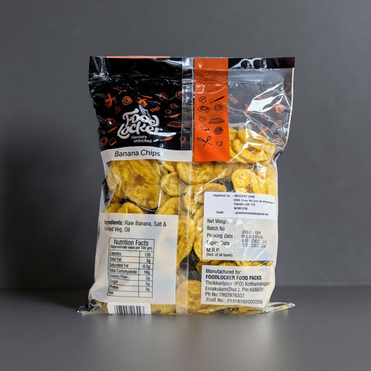 Packaged banana chips with a clear window on a gray background