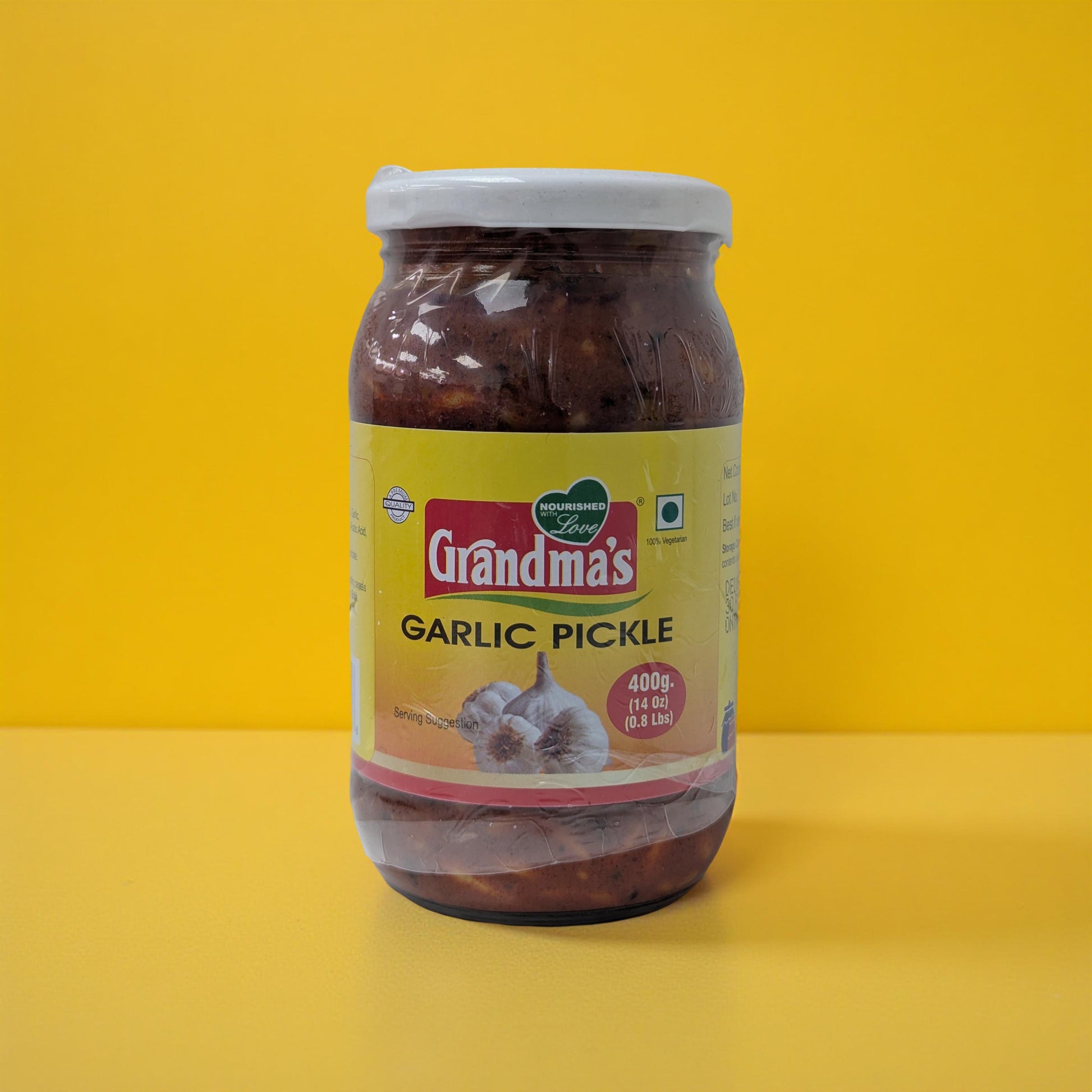 Jar of Grandma's Garlic Pickle on a yellow background