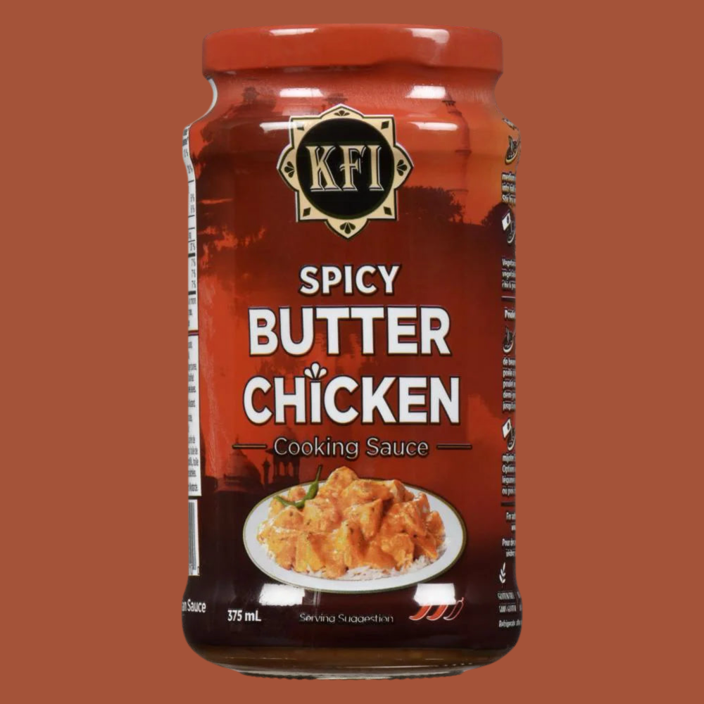 Jar of KFI Spicy Butter Chicken cooking sauce on a brown background