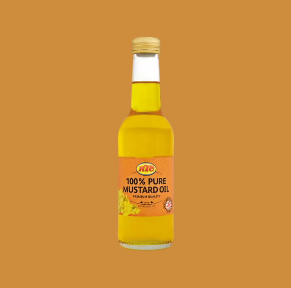 Bottle of 100% pure mustard oil on a brown background