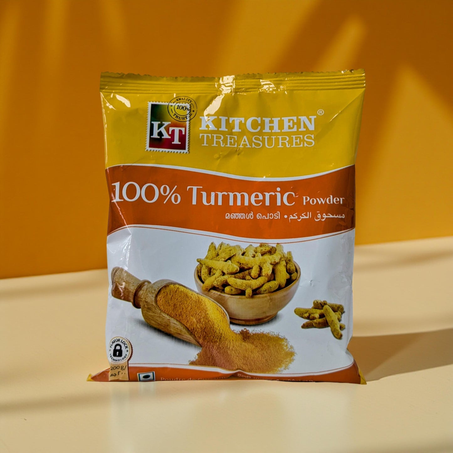 KT Kitchen Treasures 100% Turmeric Powder package on a yellow background