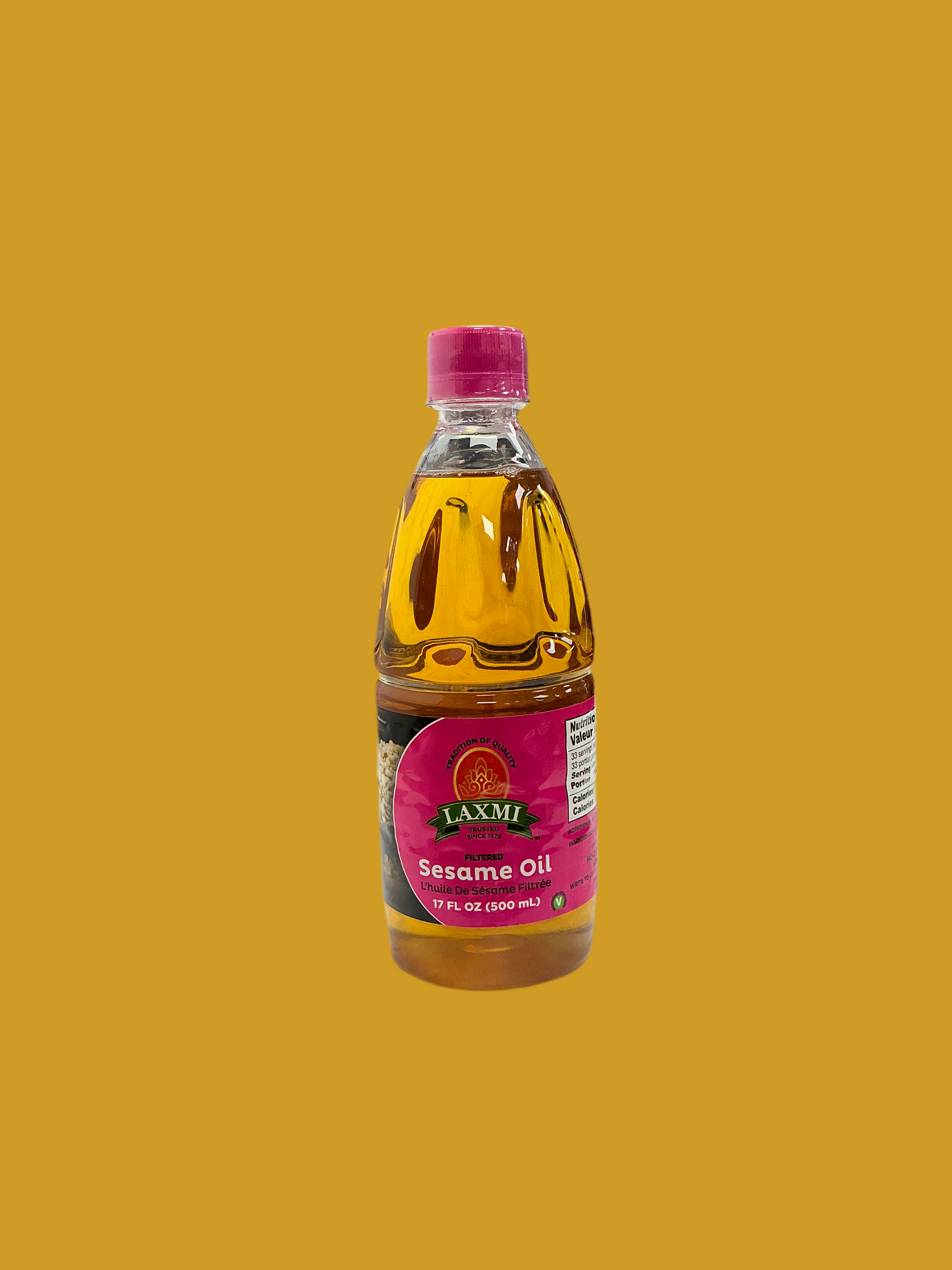 Bottle of Laxmi Sesame Oil on a mustard yellow background
