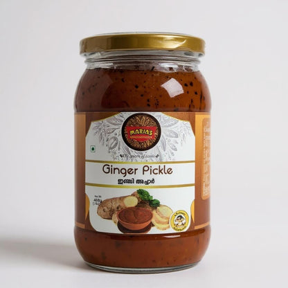 Jar of ginger pickle with a gold lid on a white background