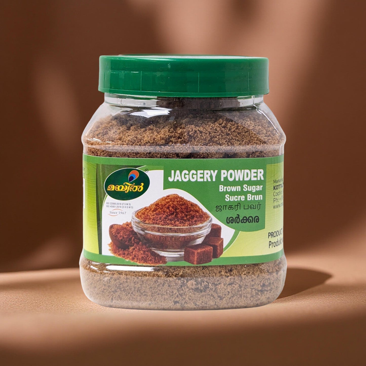 Jar of jaggery powder with a green label on a brown background