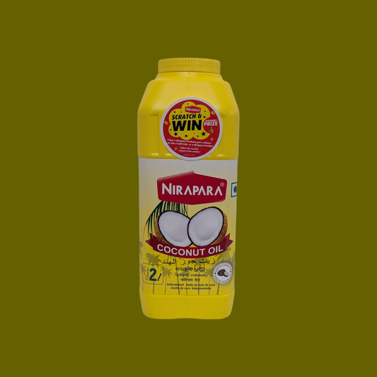 Nirapara coconut oil bottle with yellow label on a green background