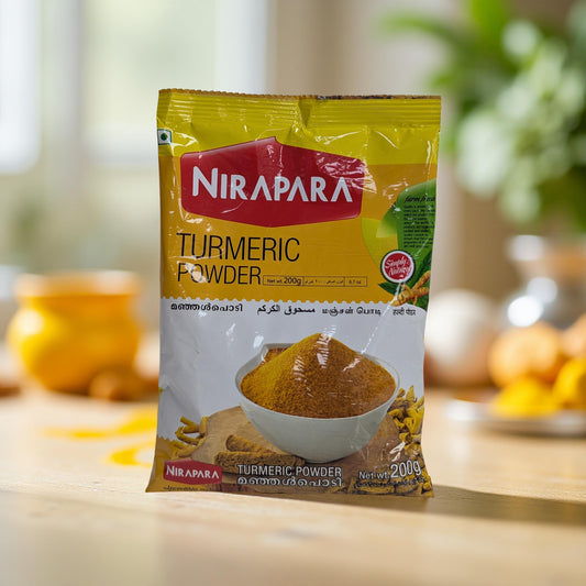 Nirapara Turmeric Powder packet on a wooden surface with a blurred background