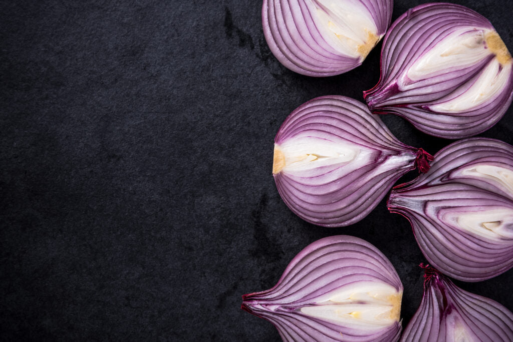 Purple onions on a dark surface