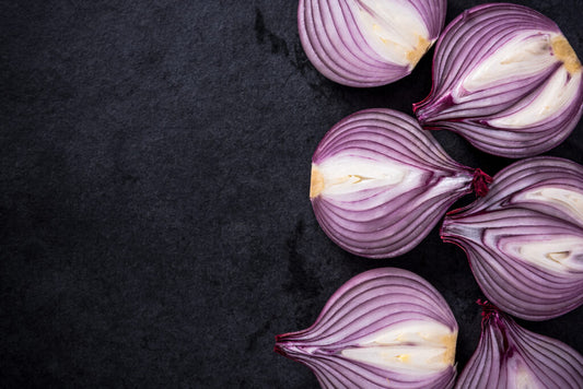 Purple onions on a dark surface