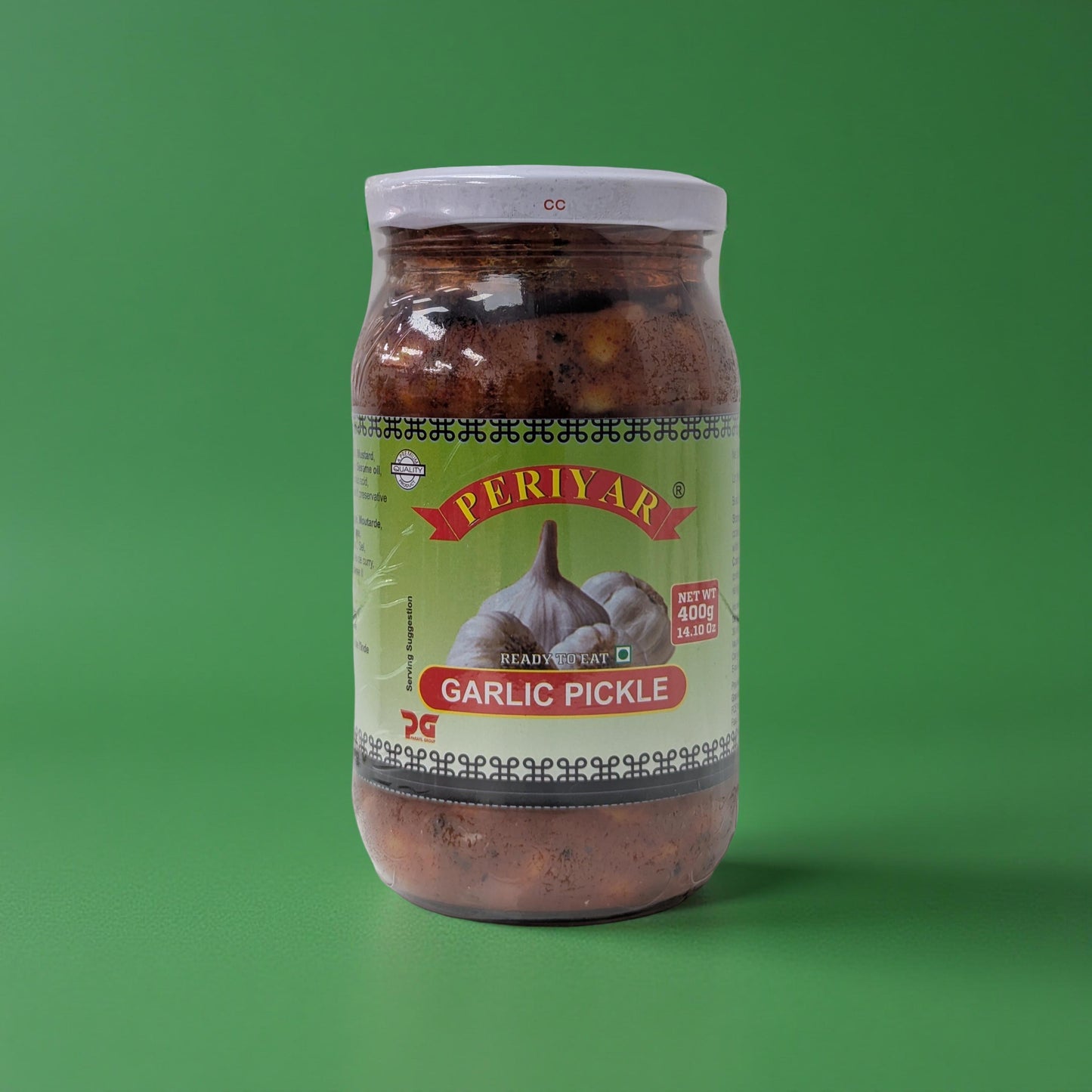 Jar of Periyar Garlic Pickle on a green background