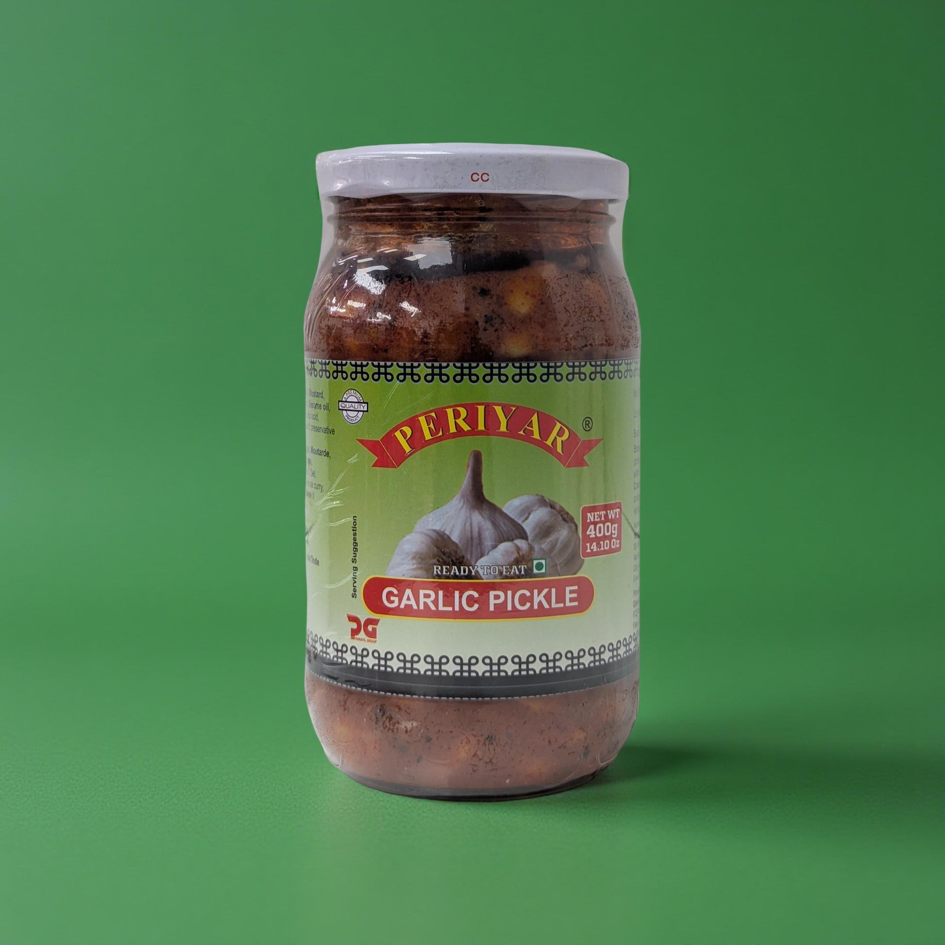 Jar of Periyar Garlic Pickle on a green background