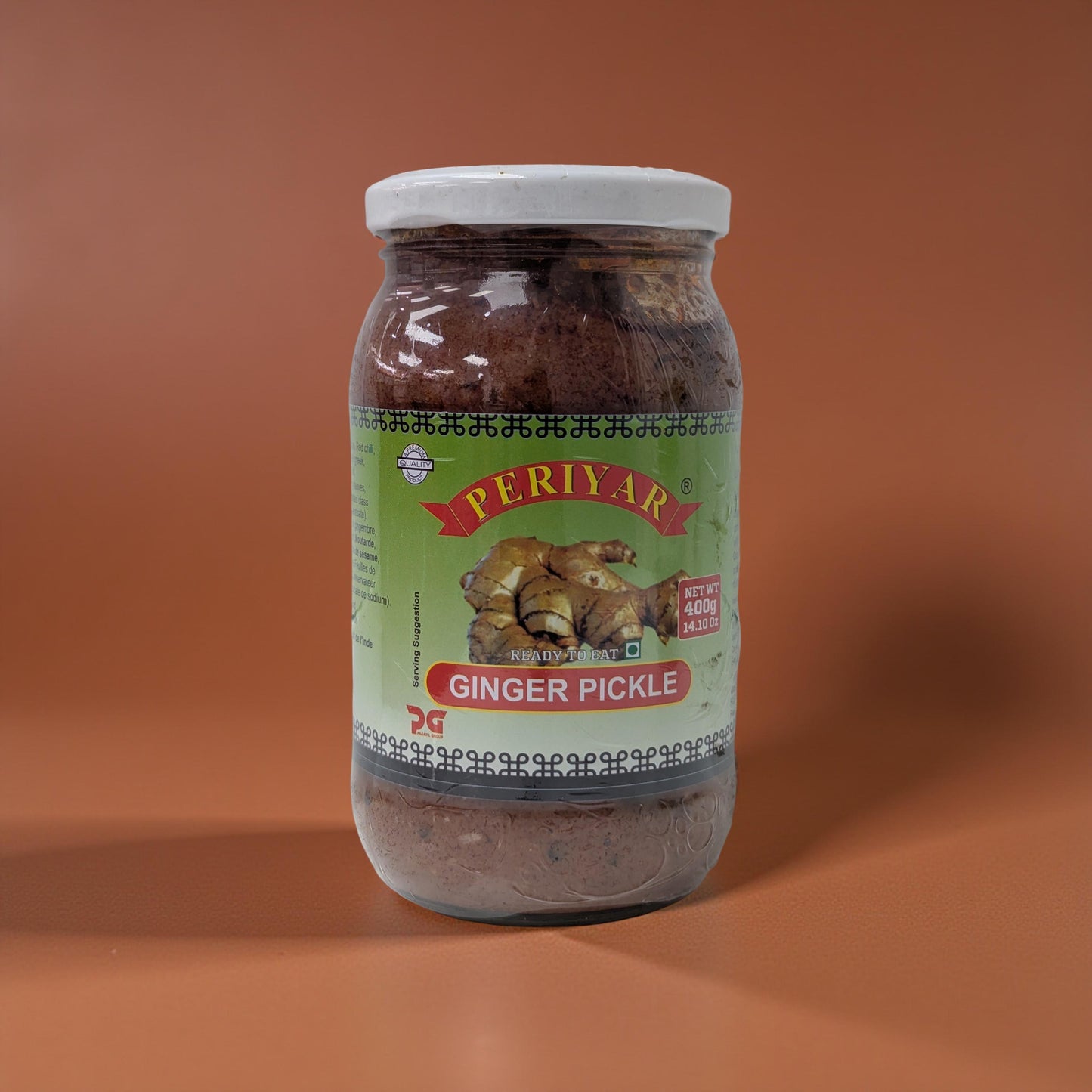 Jar of Periyar Ginger Pickle on a brown background