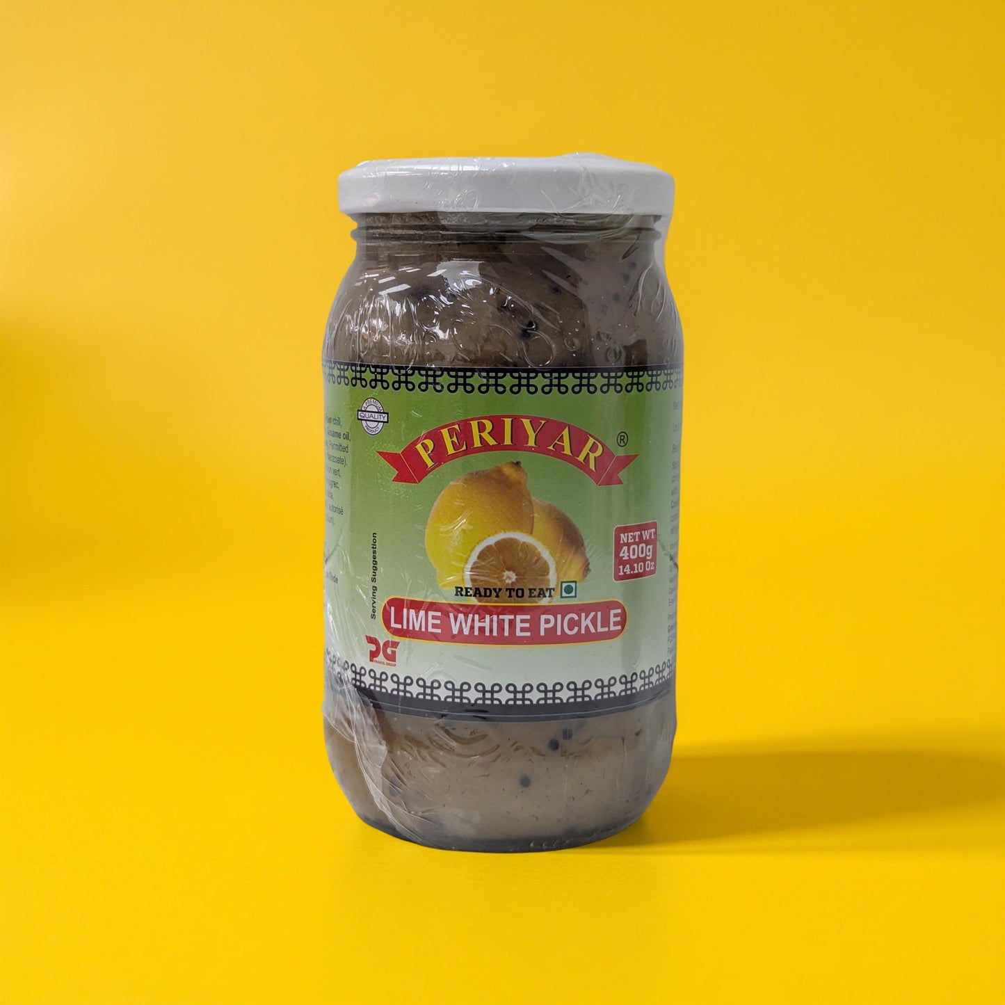 Jar of Periyar Lime White Pickle on a yellow background