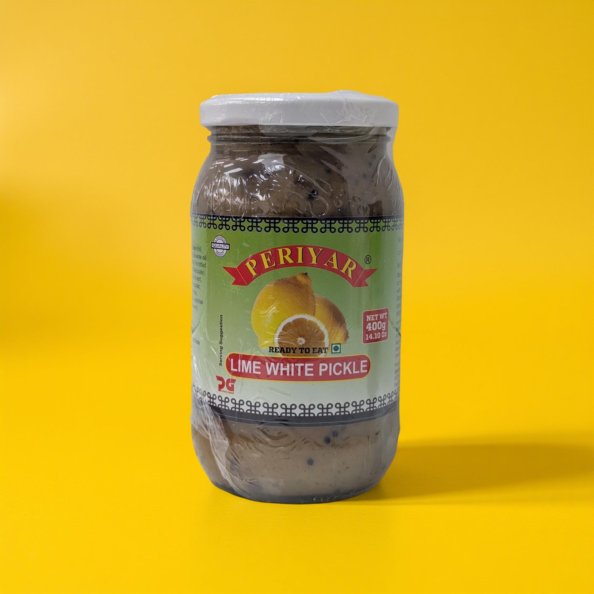 Jar of Periyar Lime White Pickle on a yellow background
