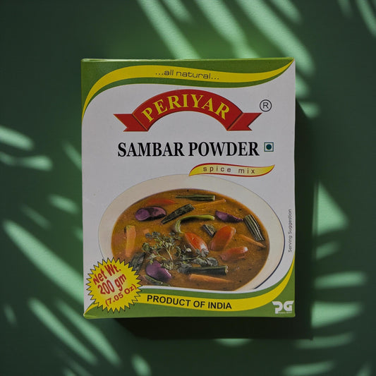 Periyar Sambar Powder spice mix packaging on a green leafy background