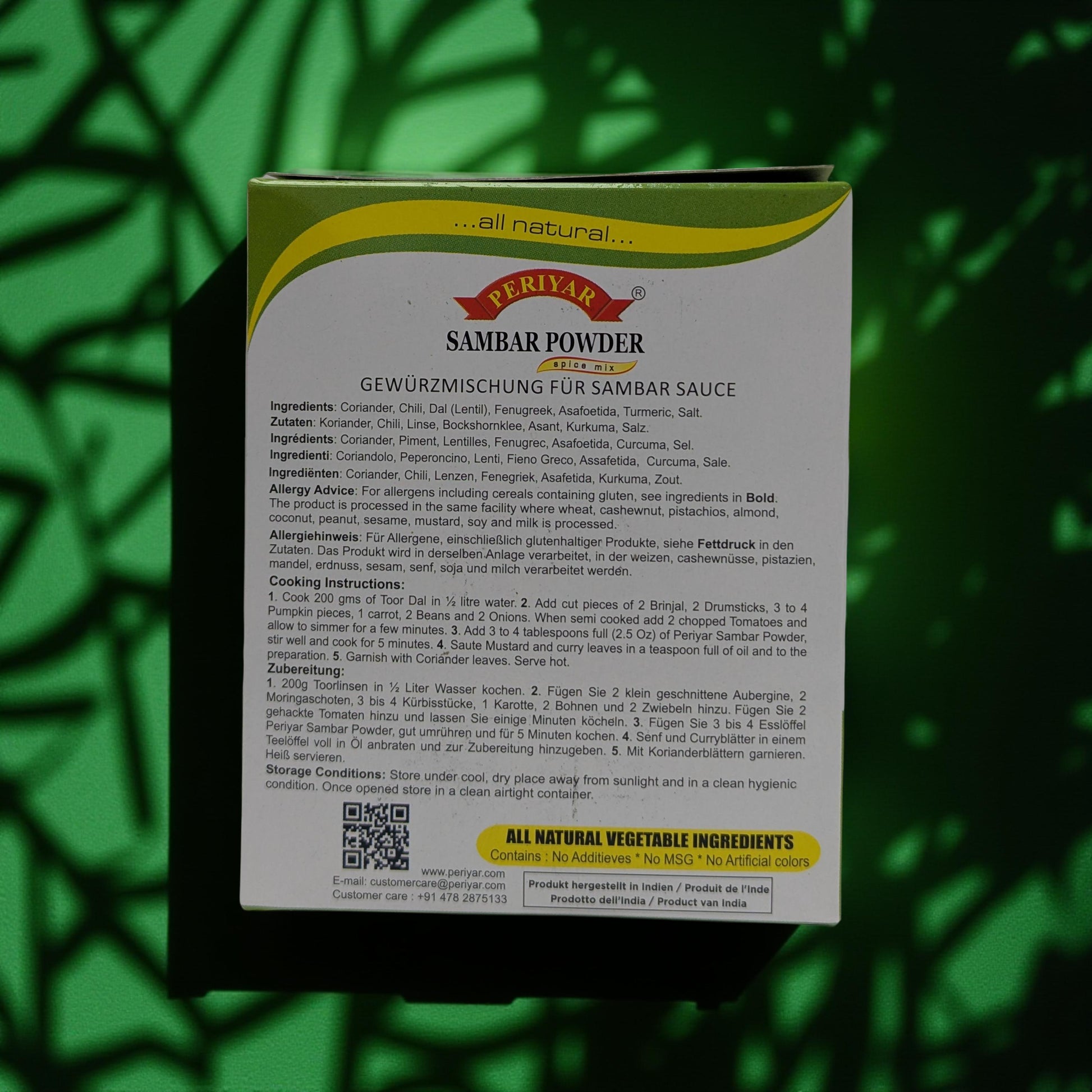 Periyar Sambar Powder packaging with text and QR code on a green leafy background