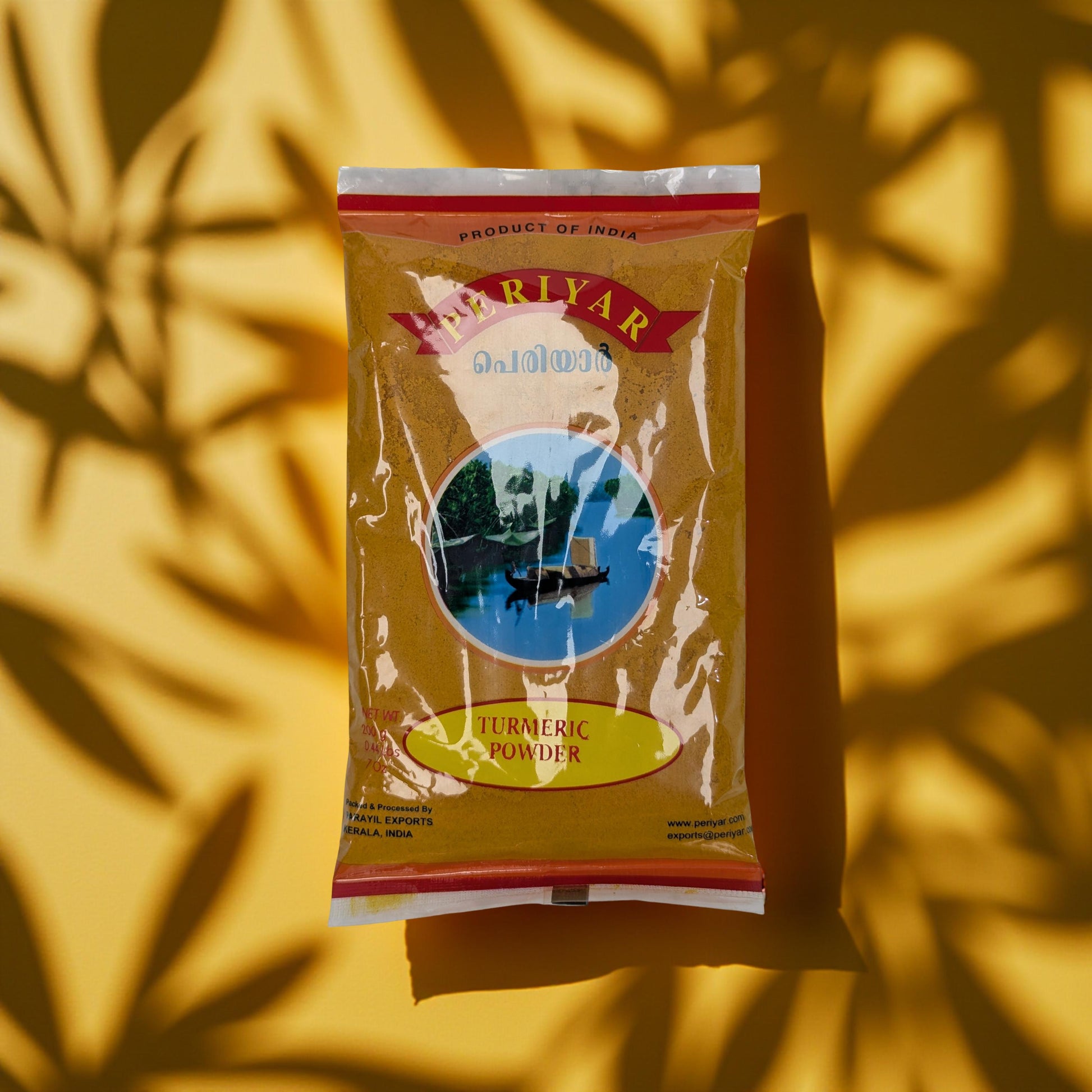 Rivar Turmeric Powder package against a yellow background with leaf shadows