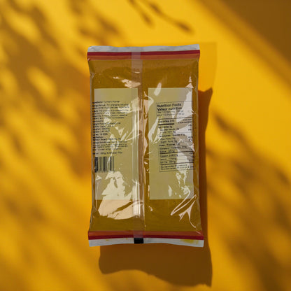 Packaged food item on a yellow background with shadow patterns