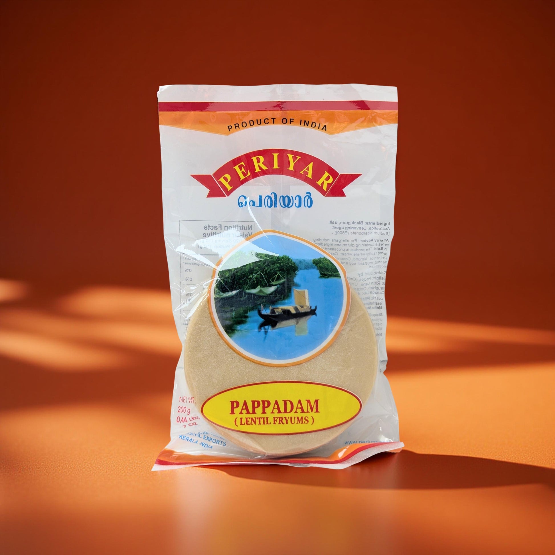 Periyar Pappadam packaging on an orange background