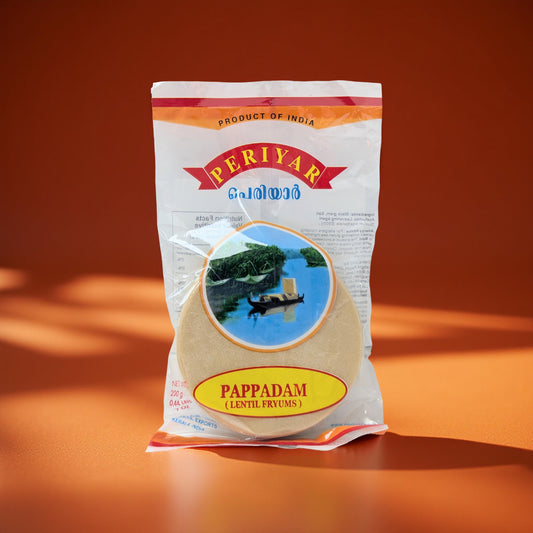 Periyar Pappadam packaging on an orange background