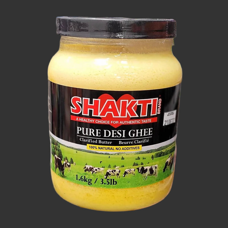 A jar of SHAKTI-PURE-DESI-GHEE-1.6-KG in black background