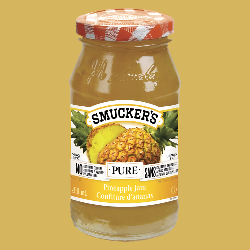 Jar of Smucker's Pineapple Jam on a yellow background