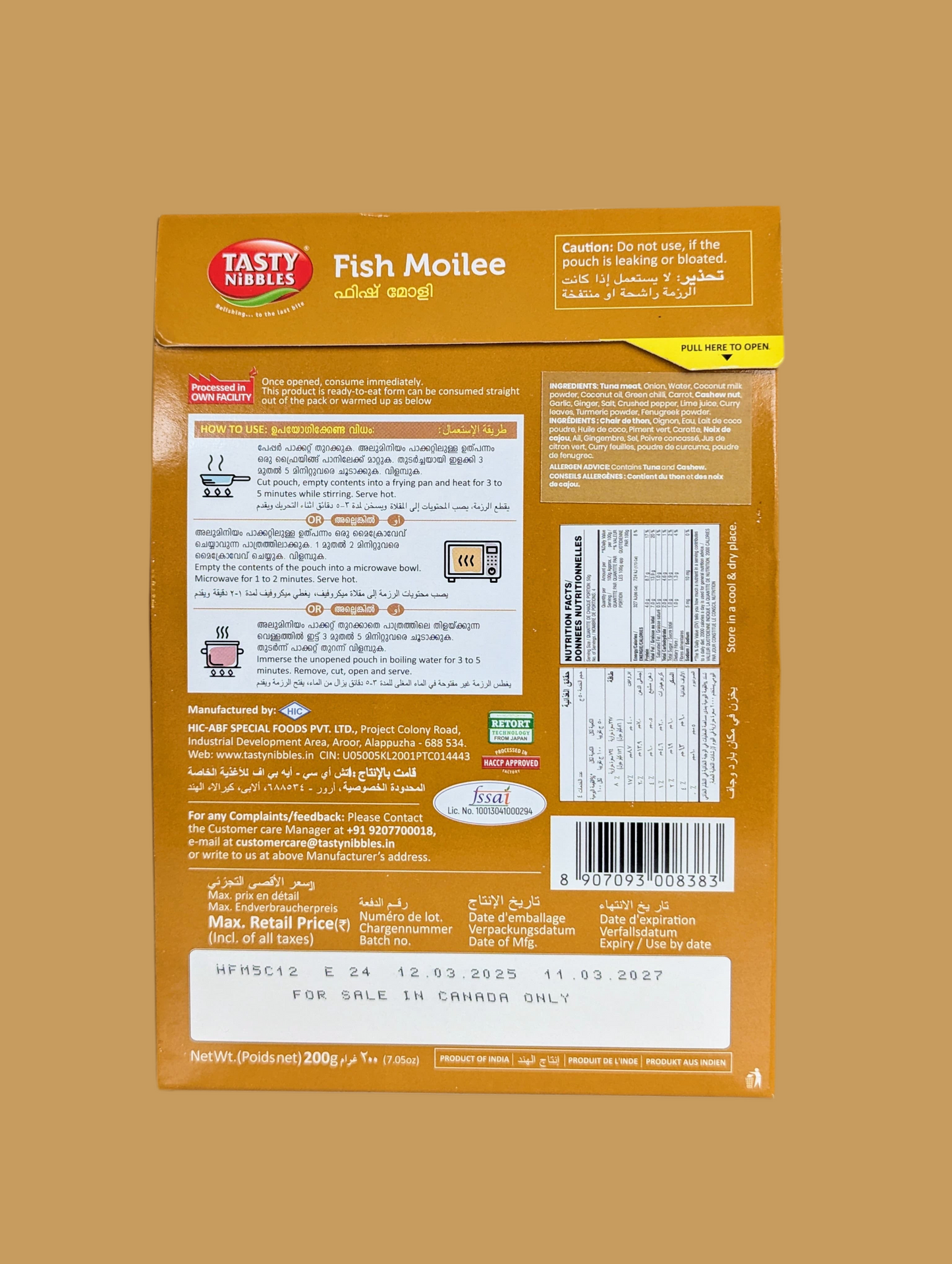 Back view of a Tasty Delight Fish Moilee packaging on a beige background