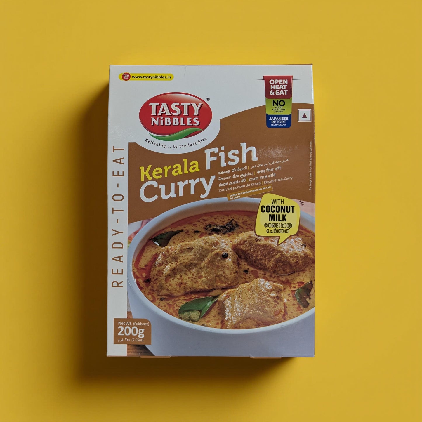 Tasty Nibbles Kerala Fish Curry packaging on a yellow background